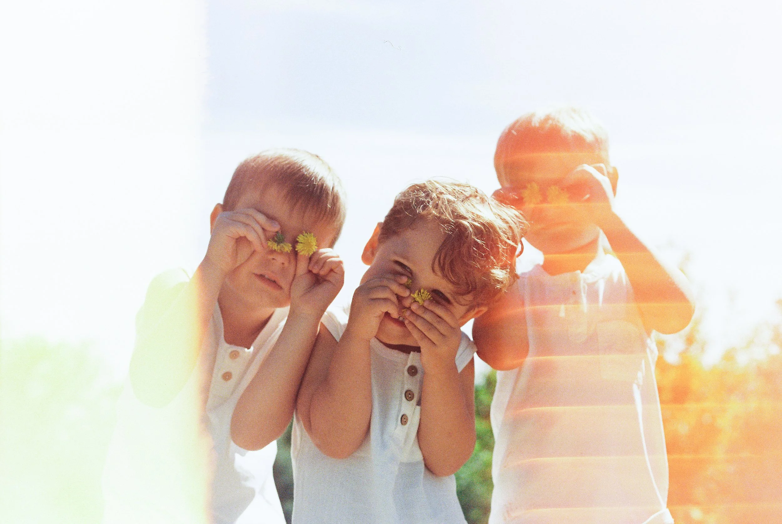 “Colorful lifestyle family captured on film, featuring natural light, bold colors, and artistic composition for a Sioux Falls family.”