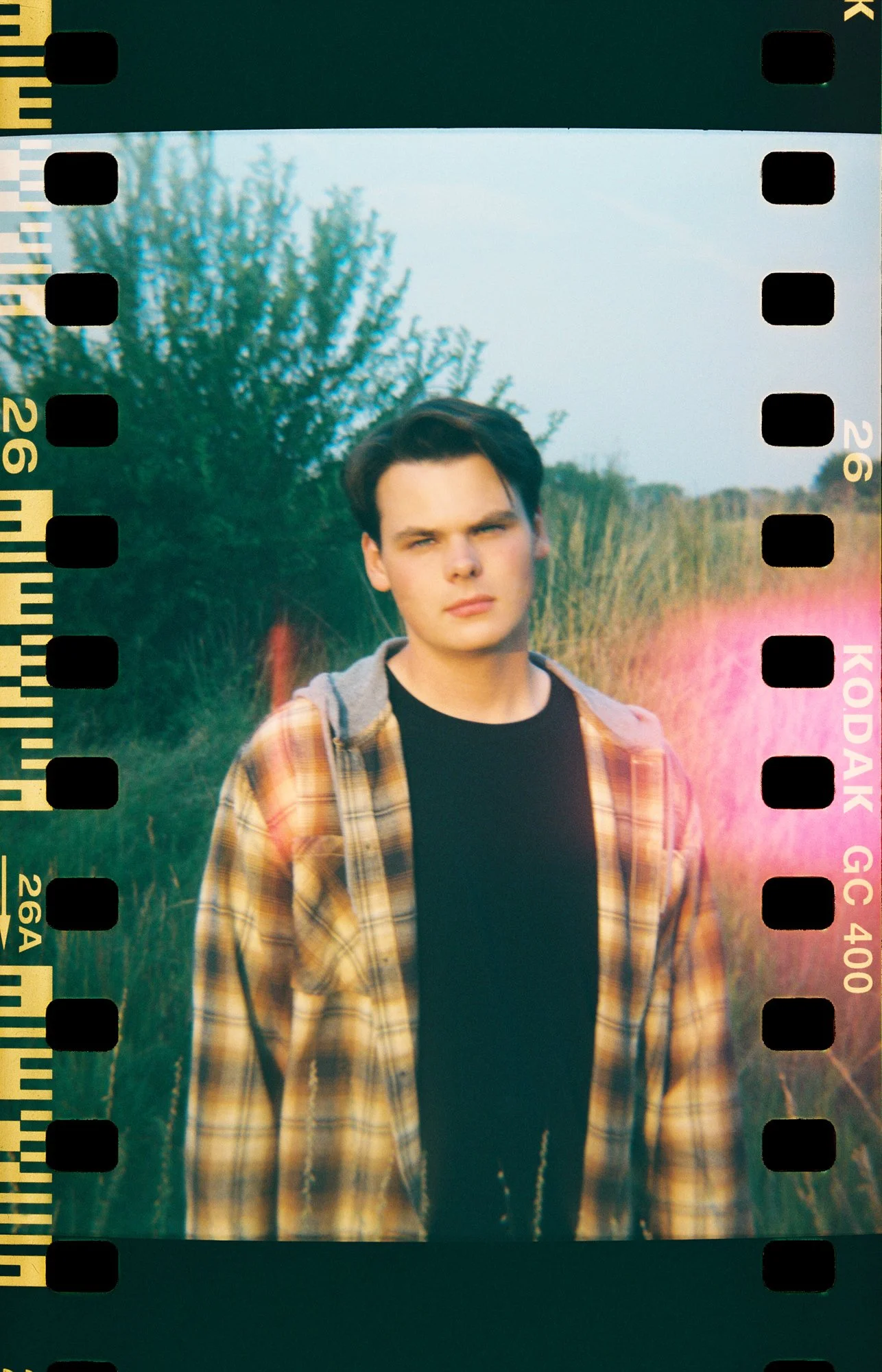 Artistic senior portrait with playful energy and soft film texture