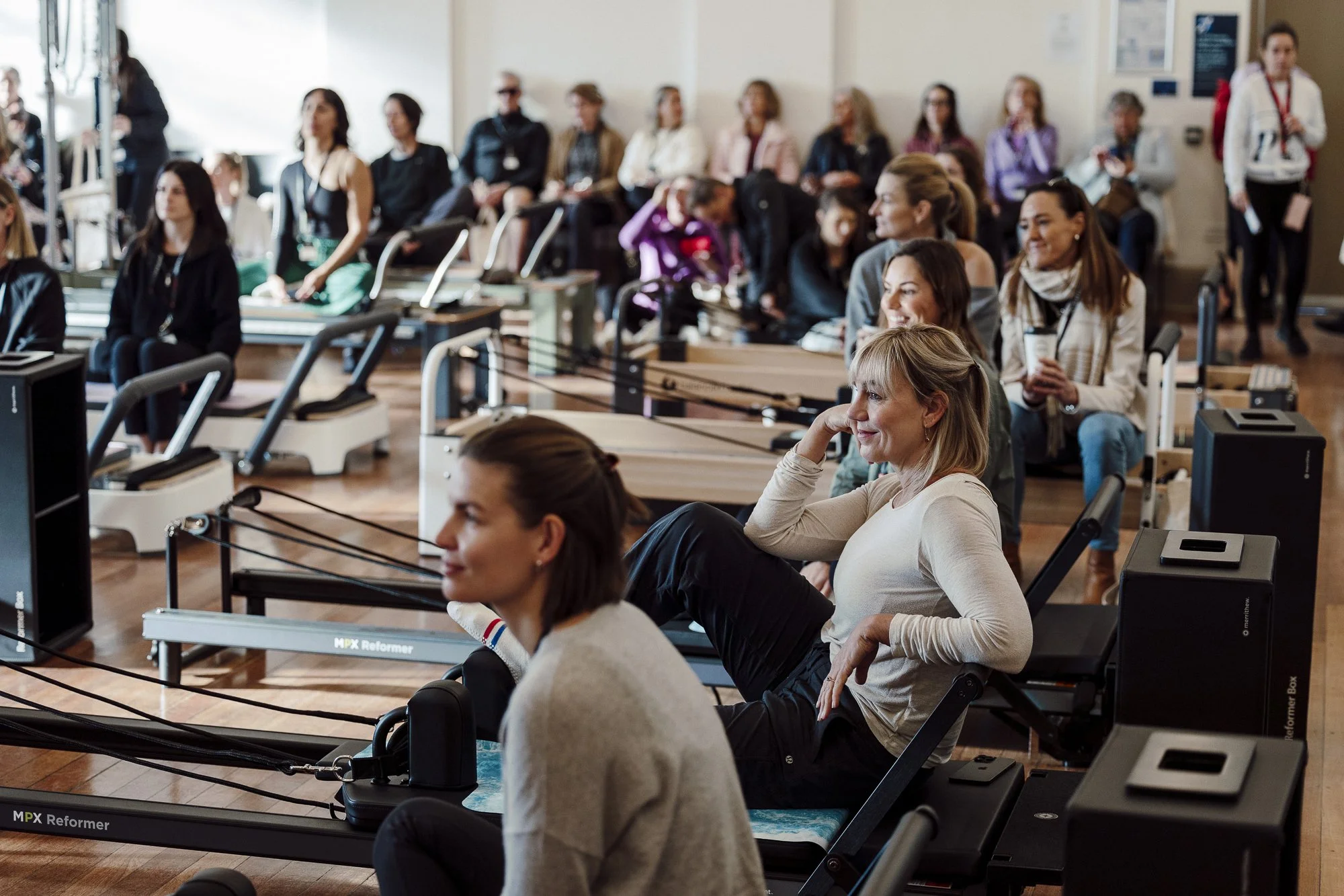 People attending a workshop on reformers at The Pilates Journal Expo.