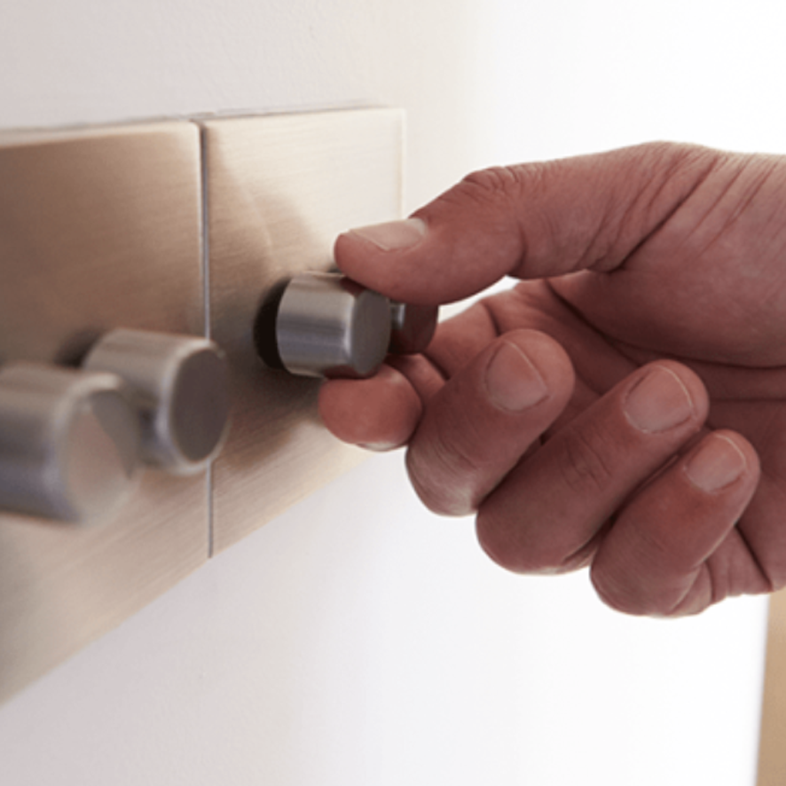 A person using a dimmer switch to control lights