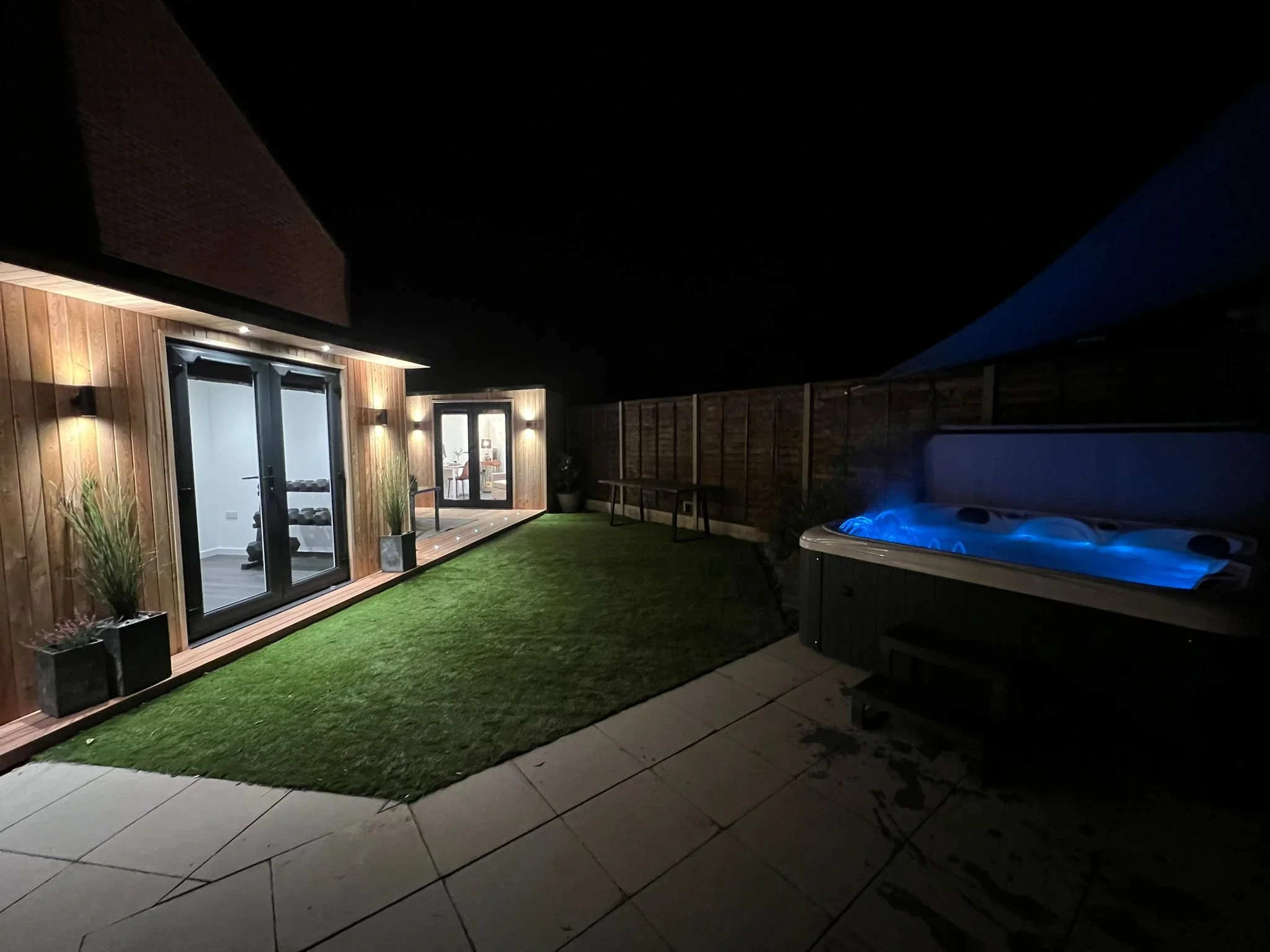 Garden gym lighting and illuminated hot tub