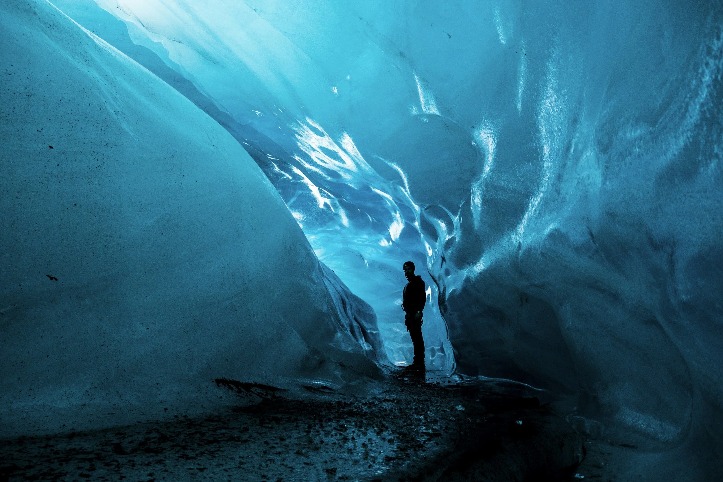 man standing inside an Iceland glacier