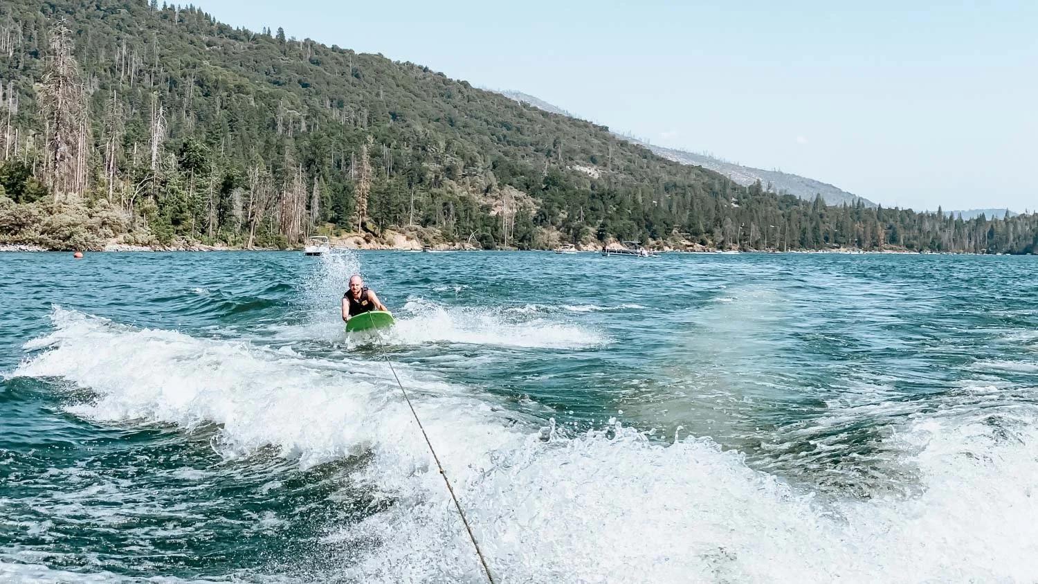 guy riding a zup board on Bass Lake