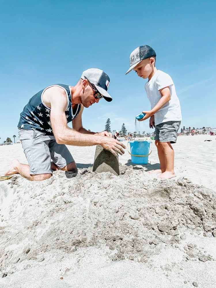 father and son playing on Coronado Beach