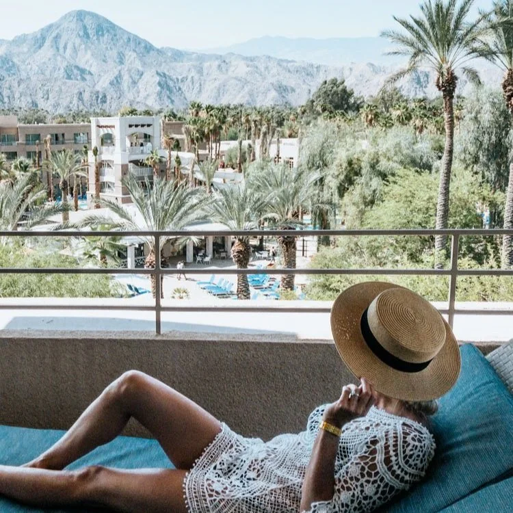 woman sitting on balcony overlooking Indian Wells resort