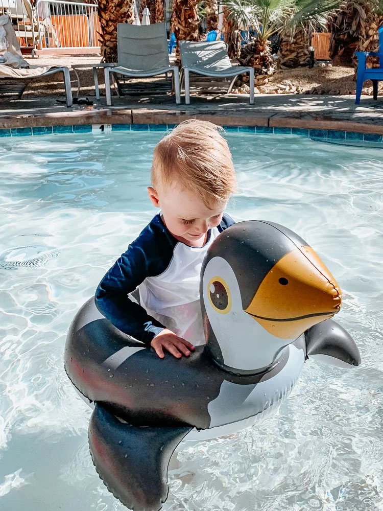 toddler in penguin floaty in Palm springs resort pool