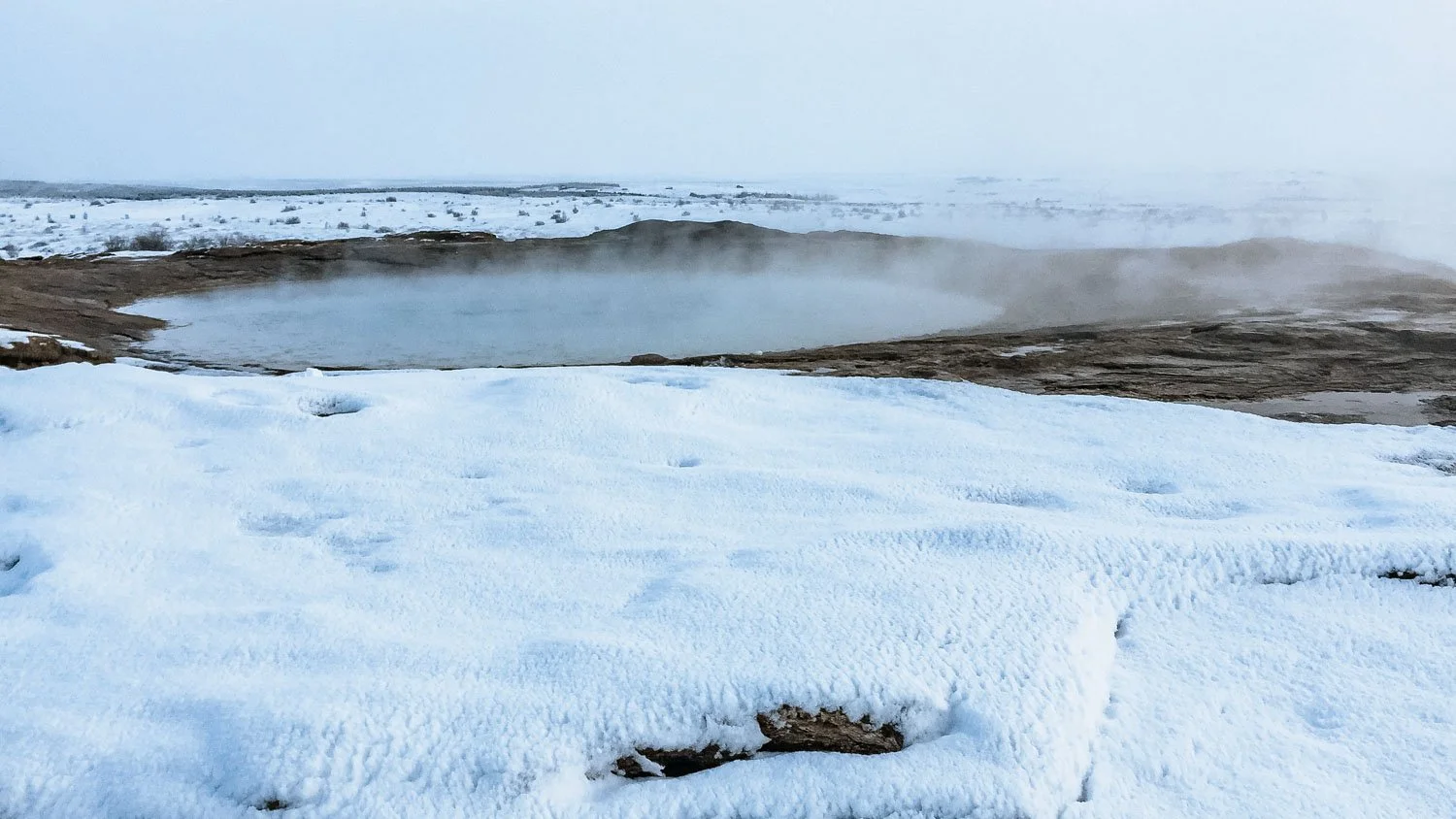 Iceland hot spring surrounded by snow
