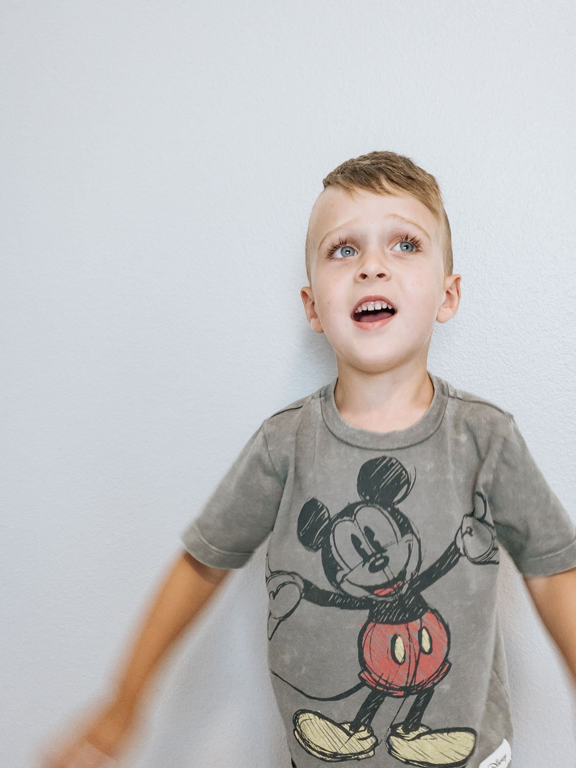 Little boy singing Disney songs and getting excited for family trips to Disneyland