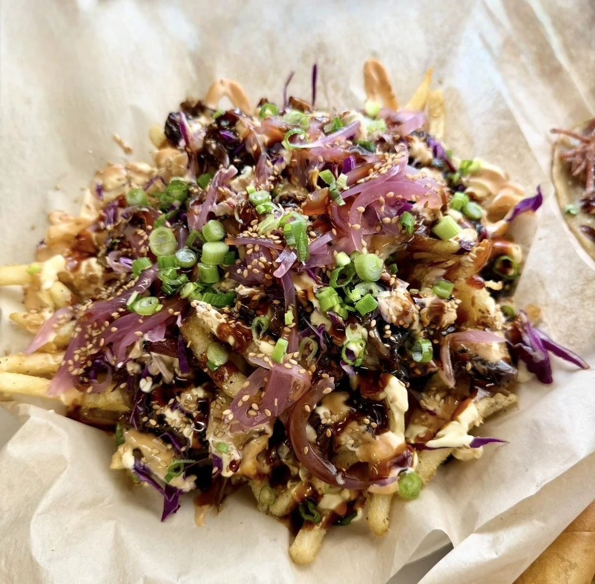 Loaded fries topped BBQ pulled pork in Korean bulgogi sauce.