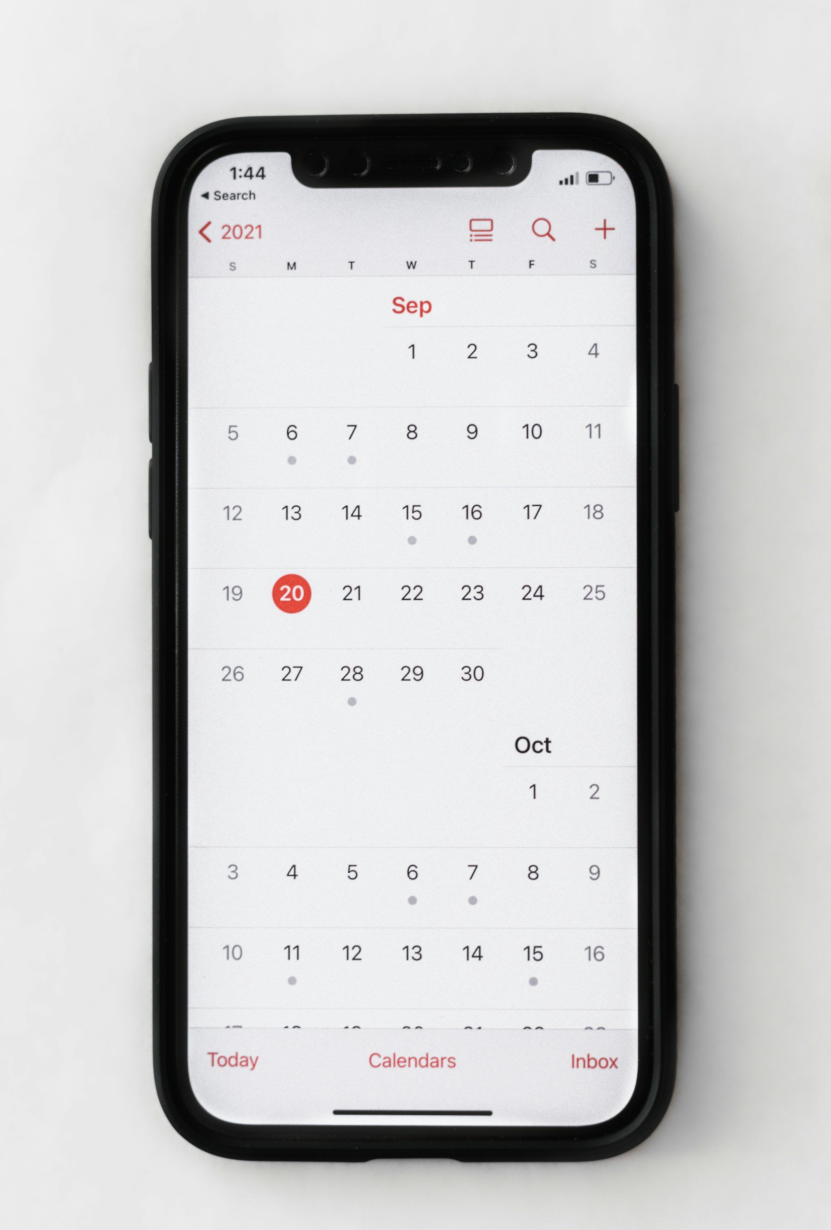 Smartphone displaying a digital calendar for September 2021, with the date 20 highlighted in red, and navigation options at the bottom.