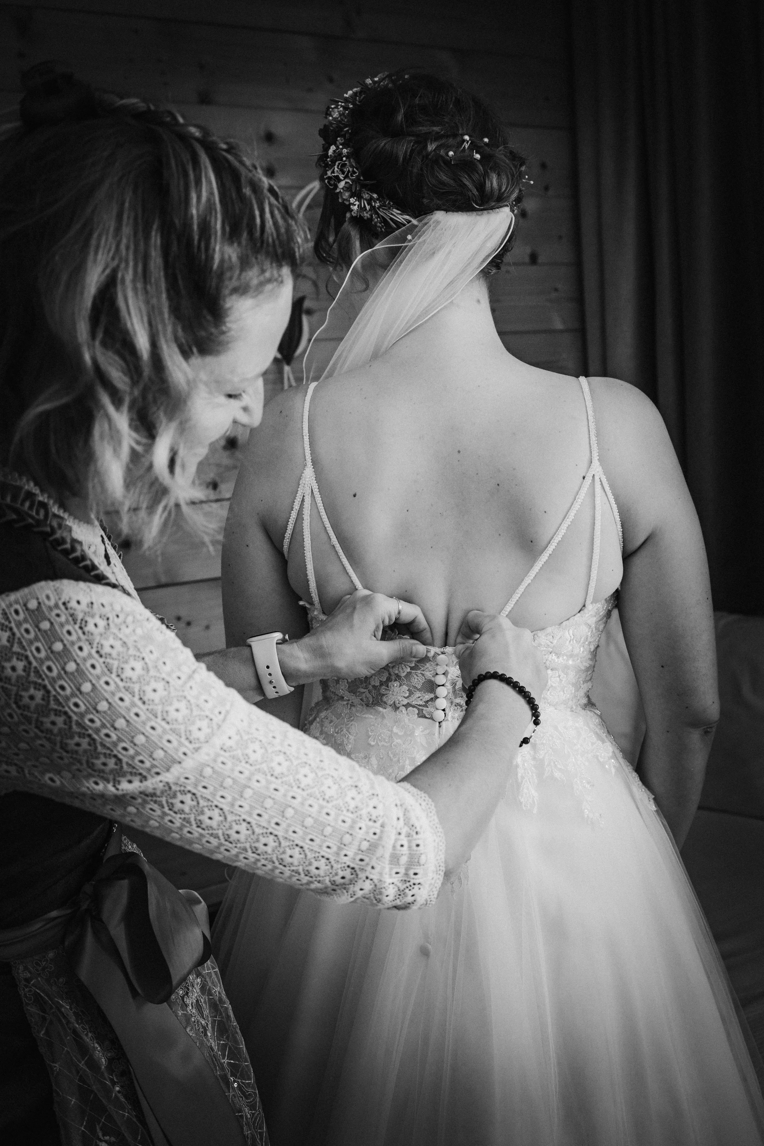 Bride getting her wedding dress buttoned