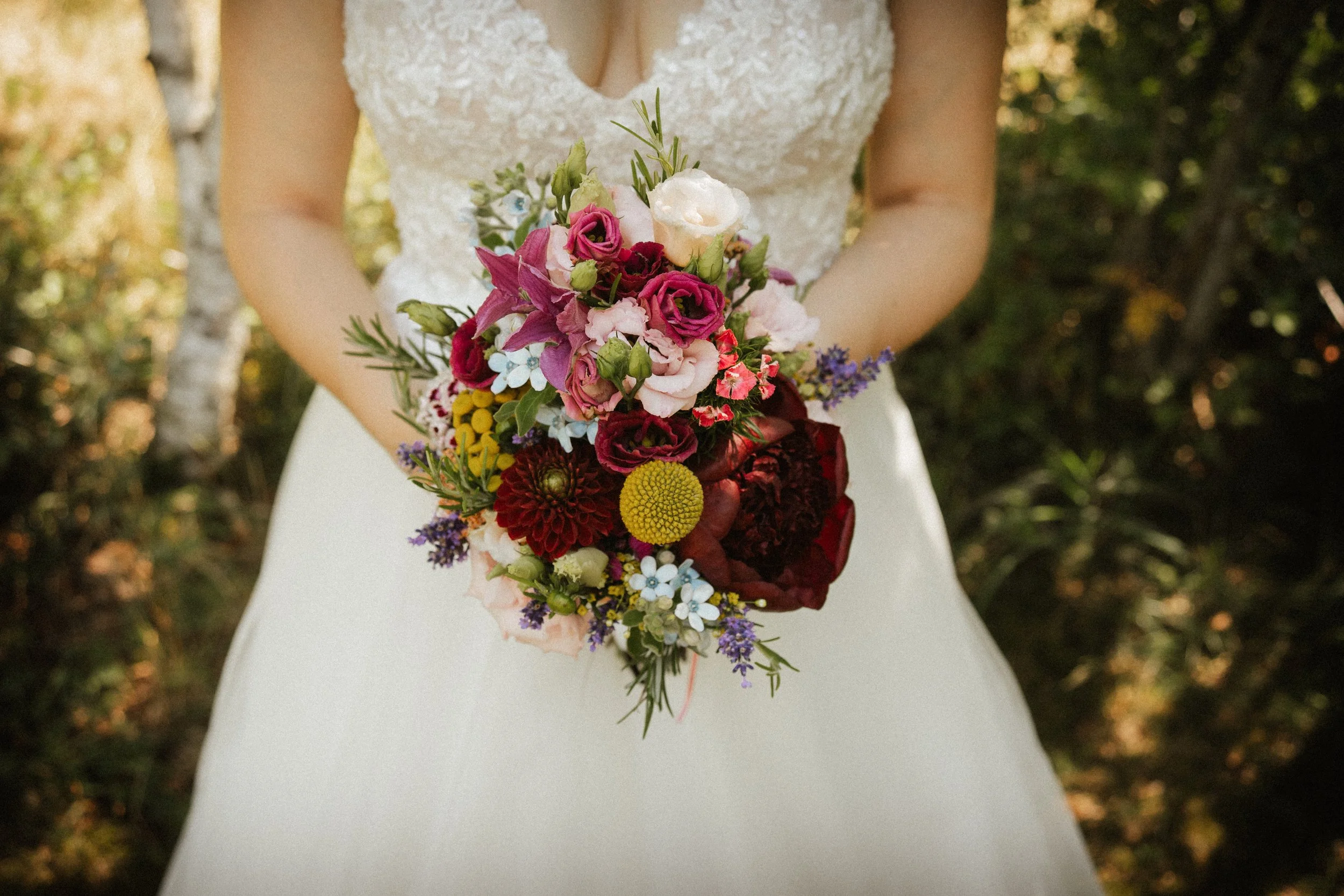 Bride holding colorful flower bouquet