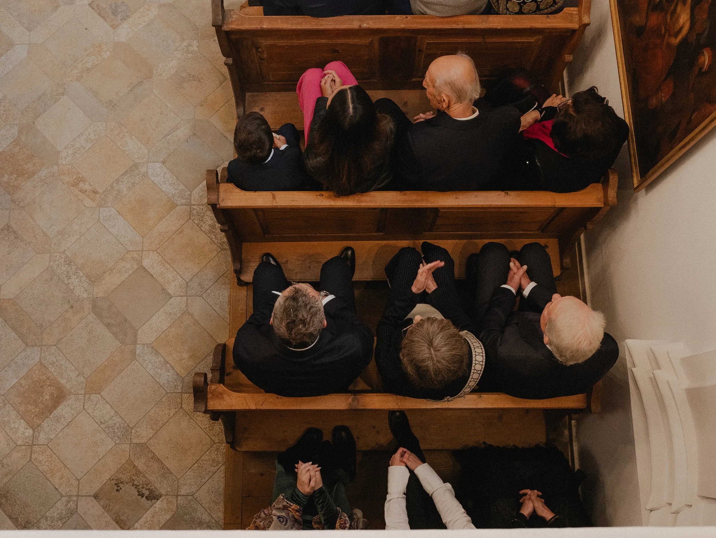 Overhead view of people seated on wooden pews