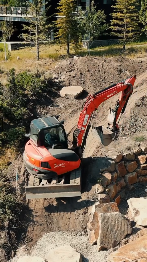 Sierra Excavation backhoe working a residential hillside lot