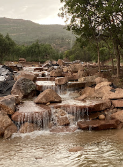 Custom water feature with stone landscaping by Sierra Excavating Utah