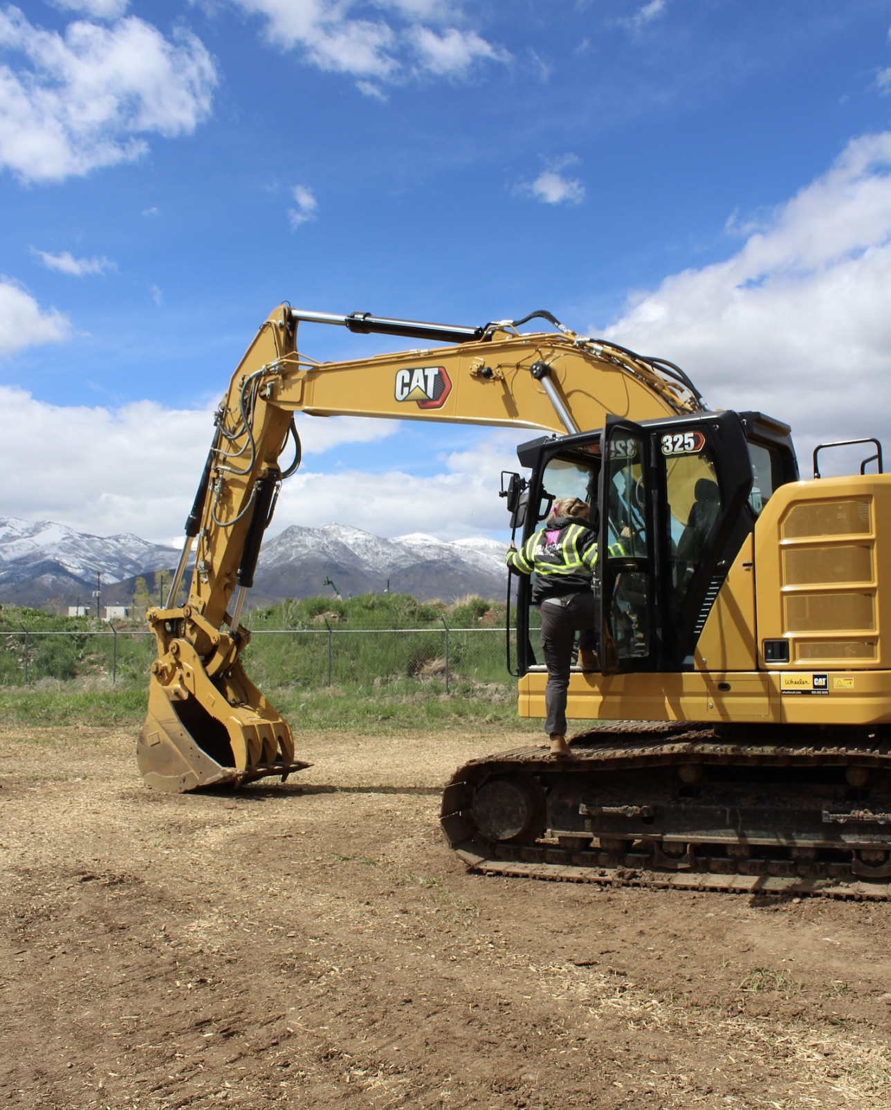 Excavator loading soil into a truck at a construction site
