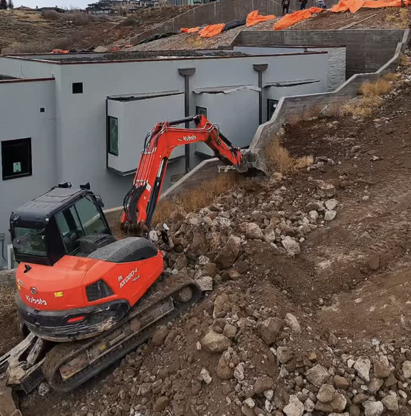 Grading and drainage work directing runoff away from a foundation