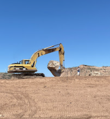 Boulder wall and natural stone retaining wall work on a mountain property