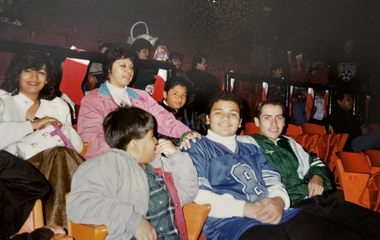Families seated together in an auditorium at a community event