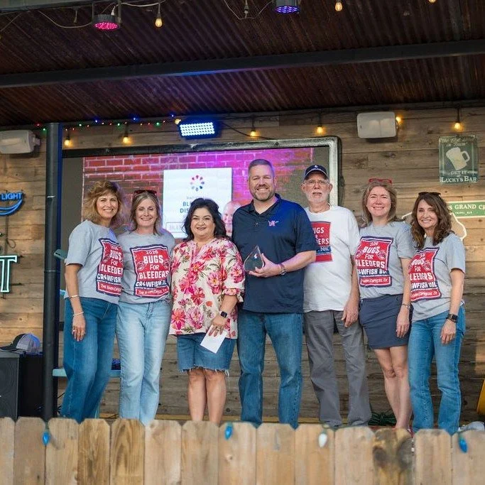 The Foster family being recognized on stage with Lone Star volunteers