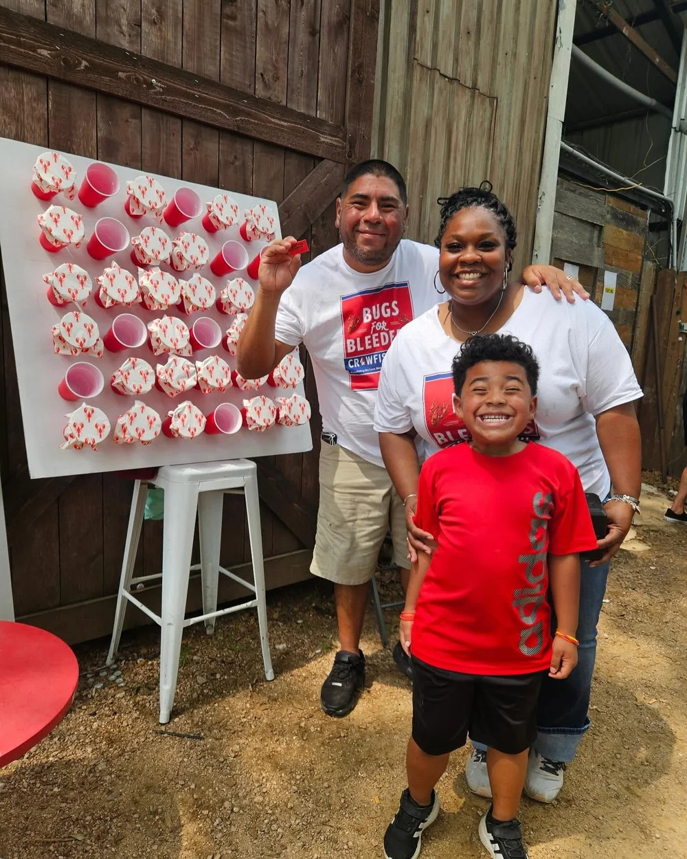 A family at the cup toss game at the Bugs for Bleeders crawfish boil
