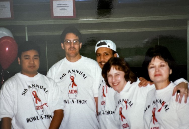 Five volunteers wearing 5th Annual Bowl-A-Thon T-shirts