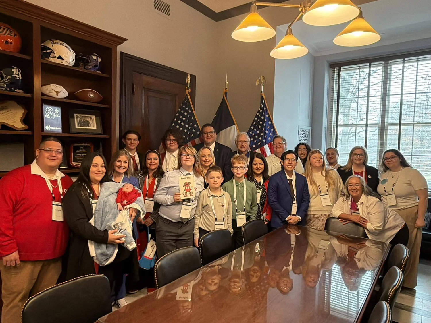 Texas families and advocates gathered in a congressional office in Washington, United States and Texas flags behind them