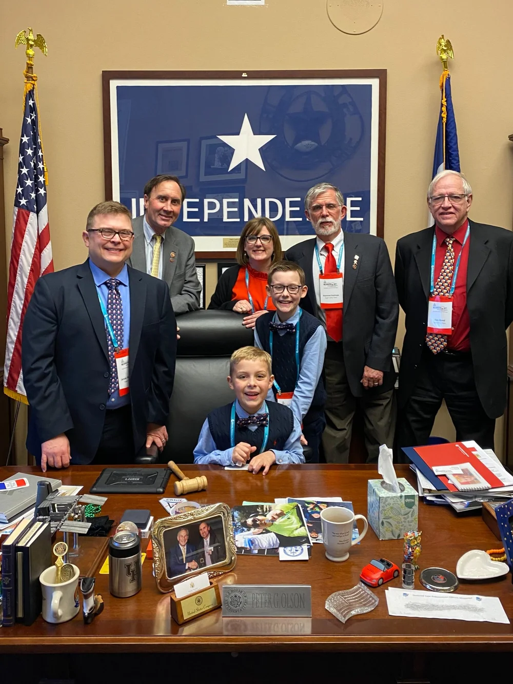 A congressional office in Washington with the United States and Texas flags beside the door