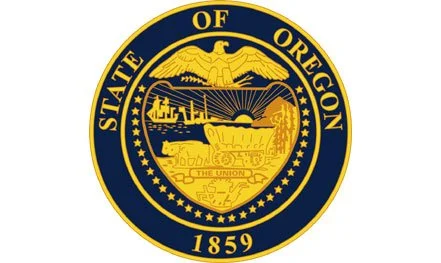 Seal of the State of Oregon featuring an eagle, mountains, a train, and a ship.