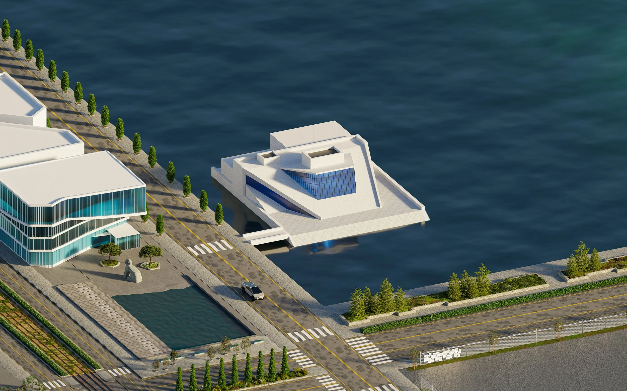 Aerial view of modern waterfront building and surrounding area with street, trees, and a vehicle.