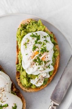 Avocado toast with poached egg and herbs on a plate