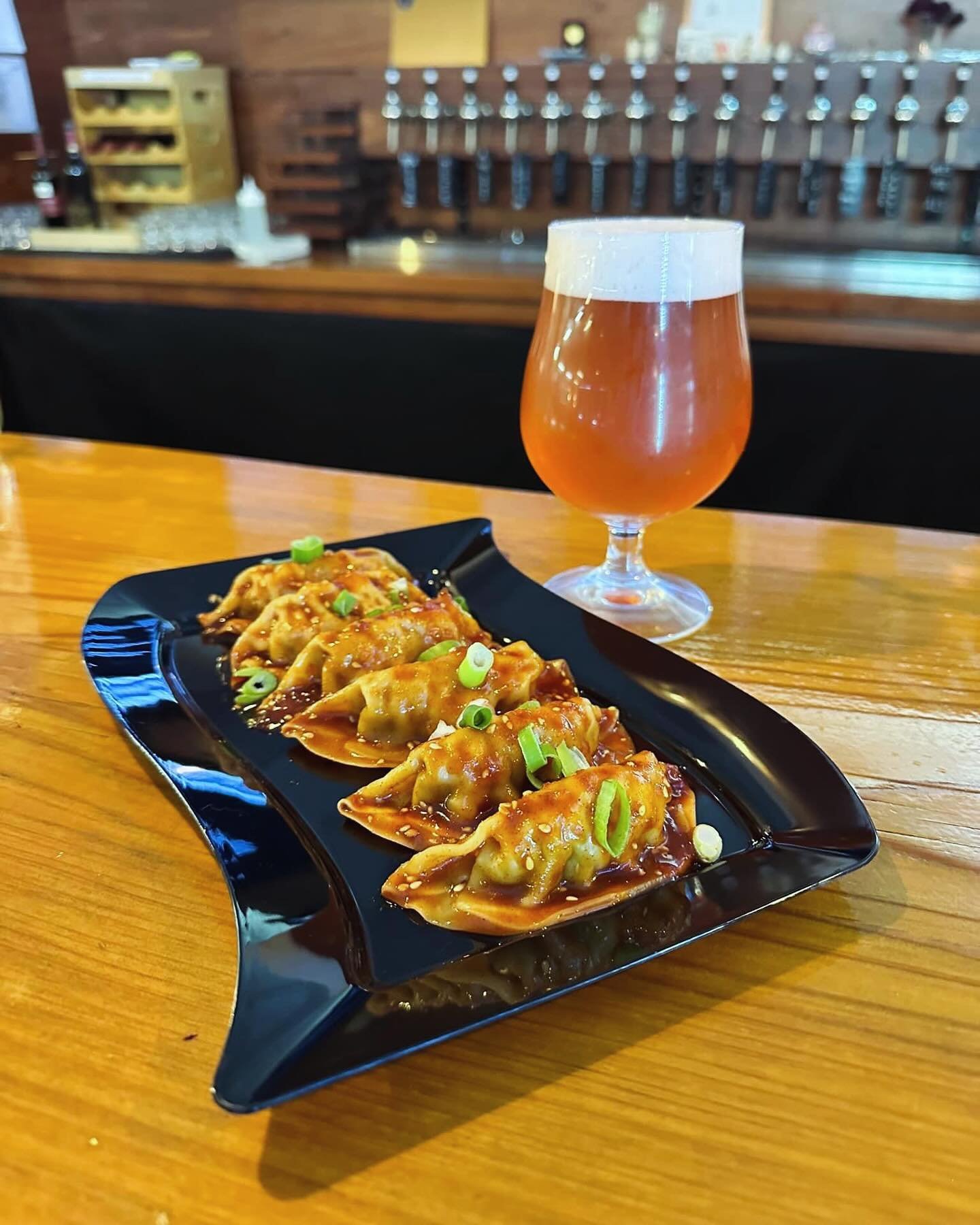 Look what Jeannie&rsquo;s cooking! Dumplings in her signature spicy sauce 🌶️!!! Enjoy some with our new New York beer, a classic cream ale brewed with loganberry.