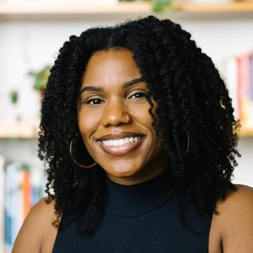 Dr. Ruby Rhoden smiling in a headshot. Dr. Rhoden is a New York therapist who offers women's counseling, burnout support & family planning help. Learn how to get started here.