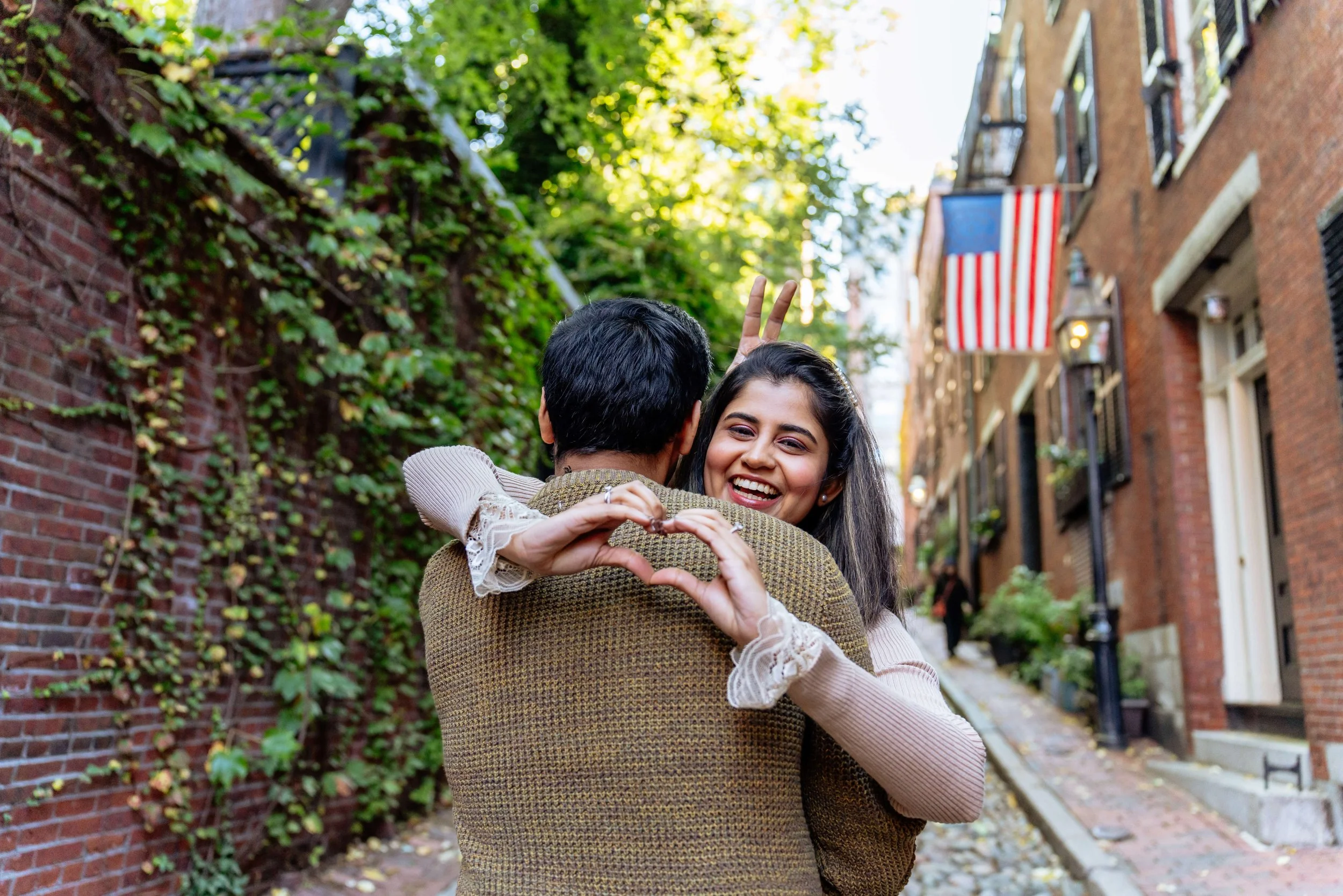 Couple sharing a romantic moment on Acorn Street in Beacon Hill during a Boston couples photography session.
