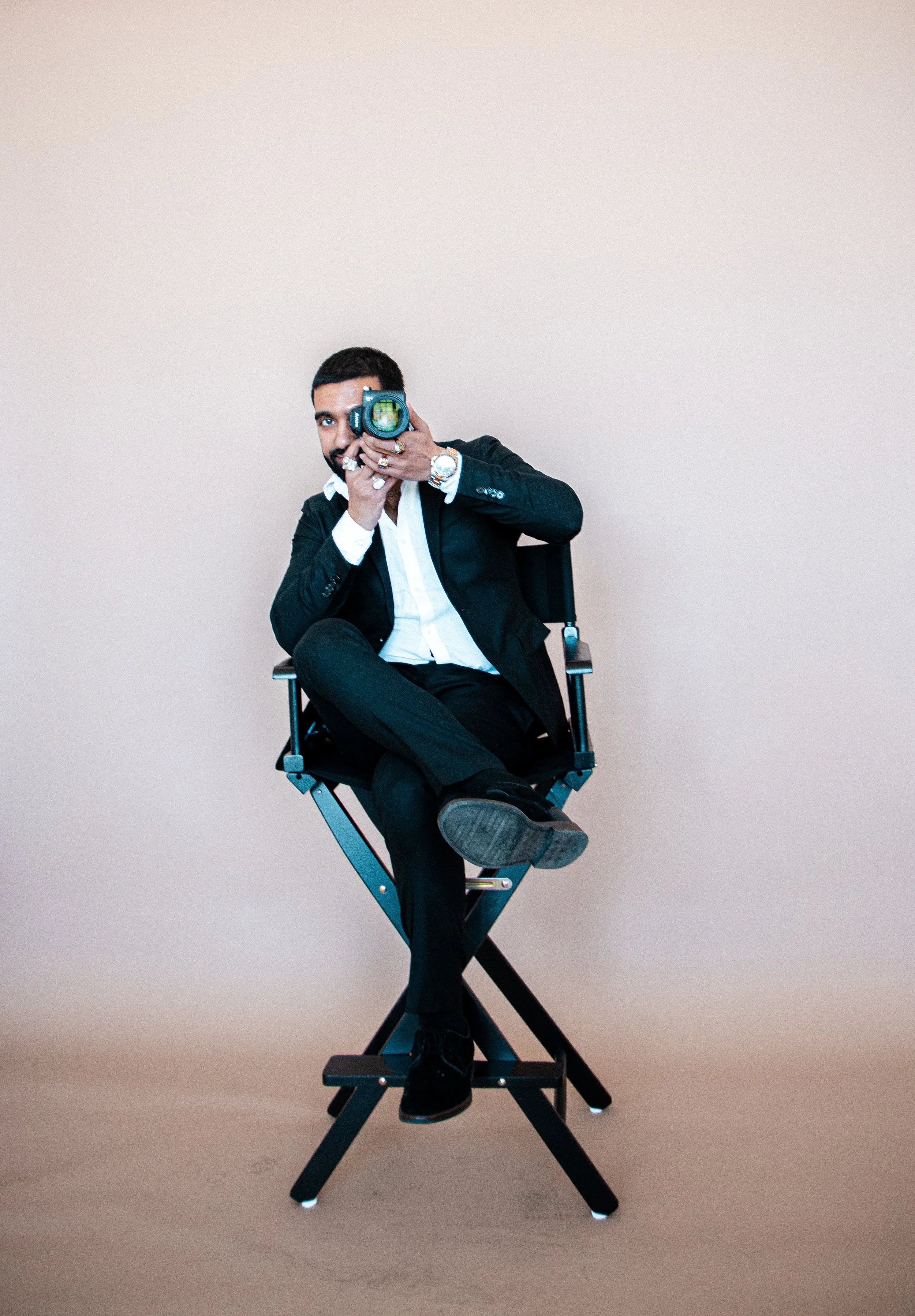 Wedding photographer Harry holding his camera during a portrait session in Boston.