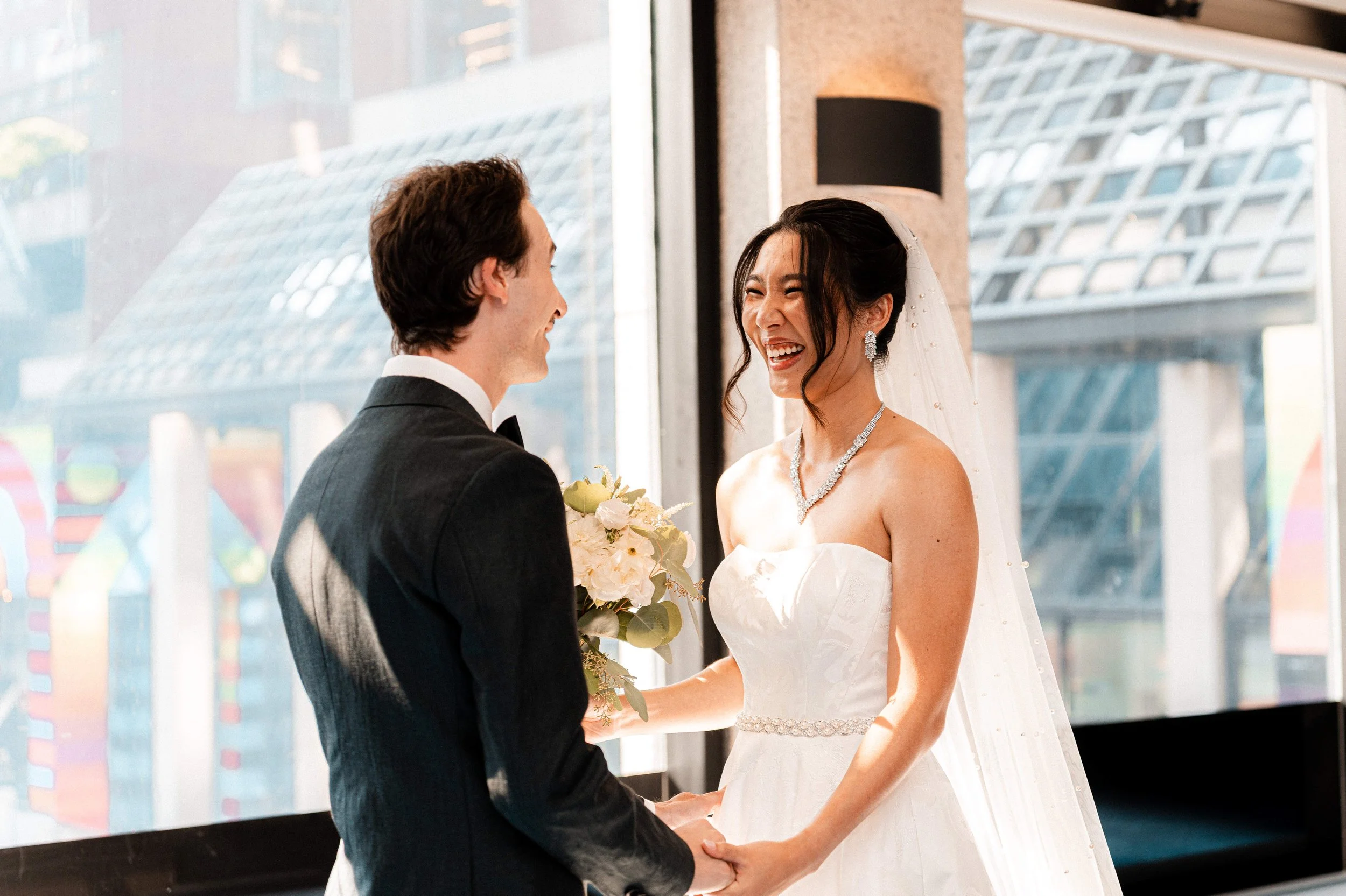 Bride and groom sharing an emotional first look at a Boston Marriott Cambridge wedding.