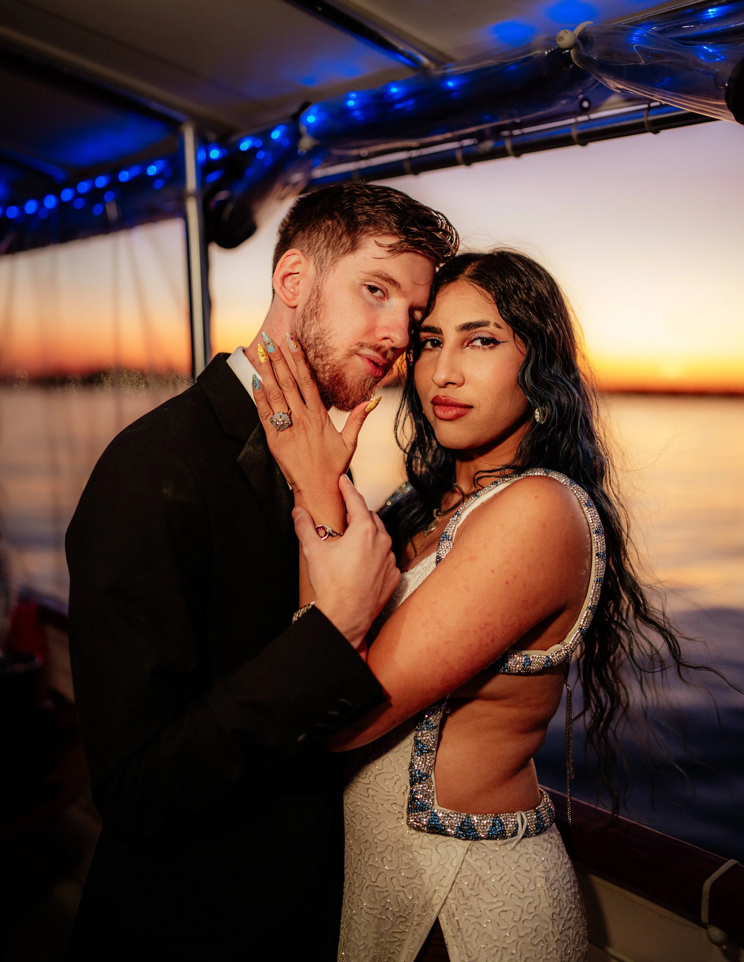 Couple embracing during a romantic sunset couples photography session overlooking the ocean in Boston.