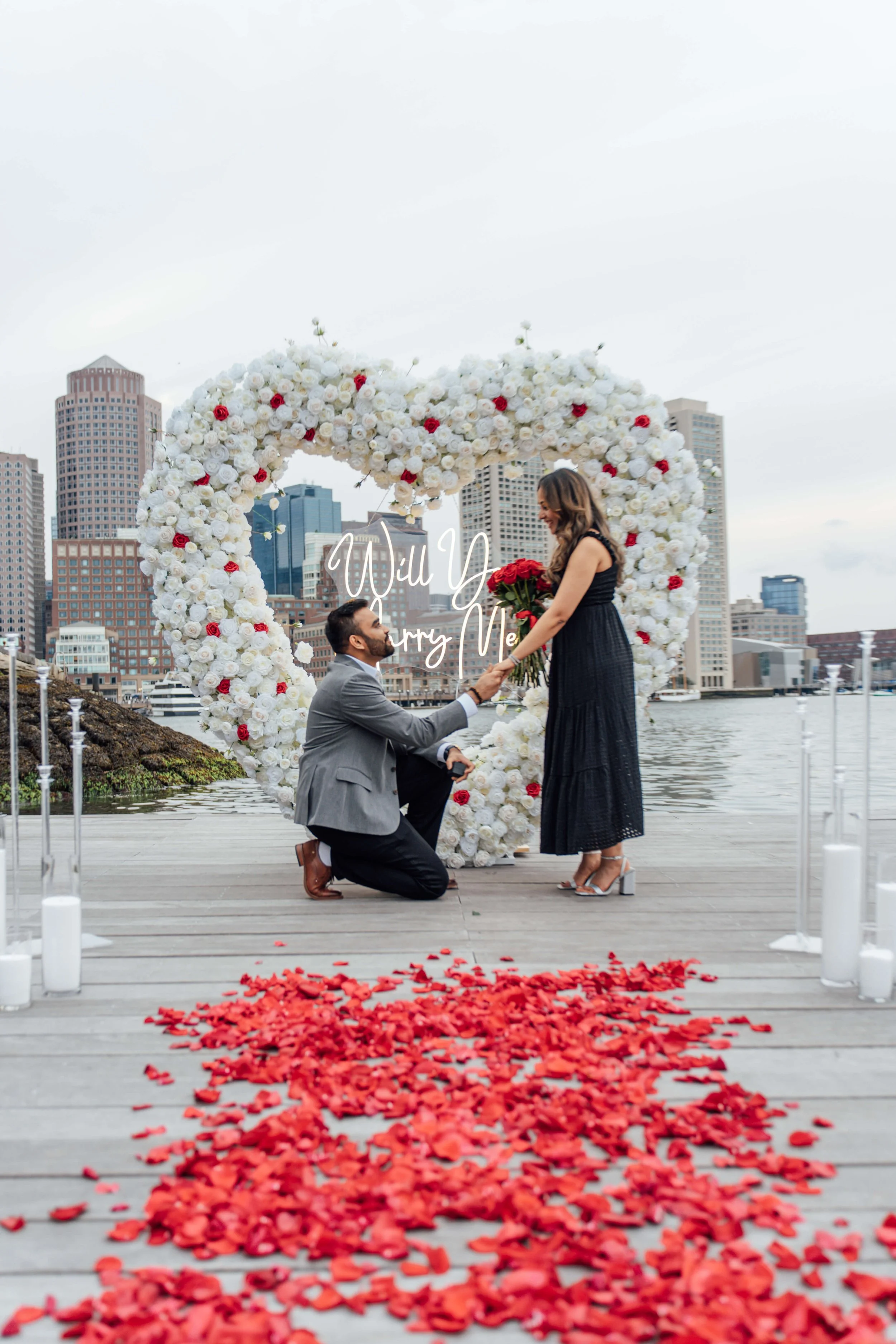 Surprise proposal at Boston Seaport waterfront captured by Boston proposal photographer