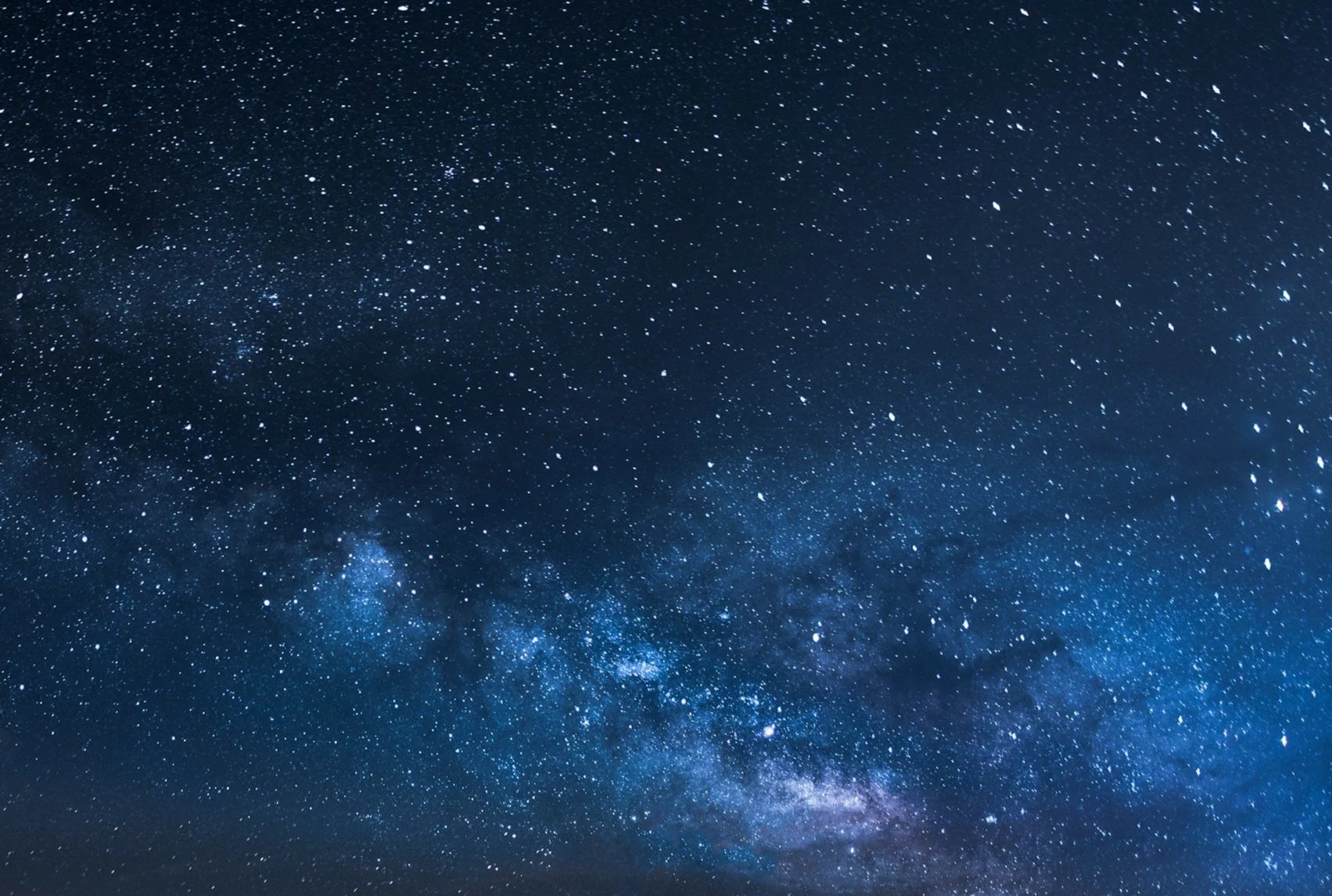 Night sky filled with stars and the Milky Way galaxy visible.