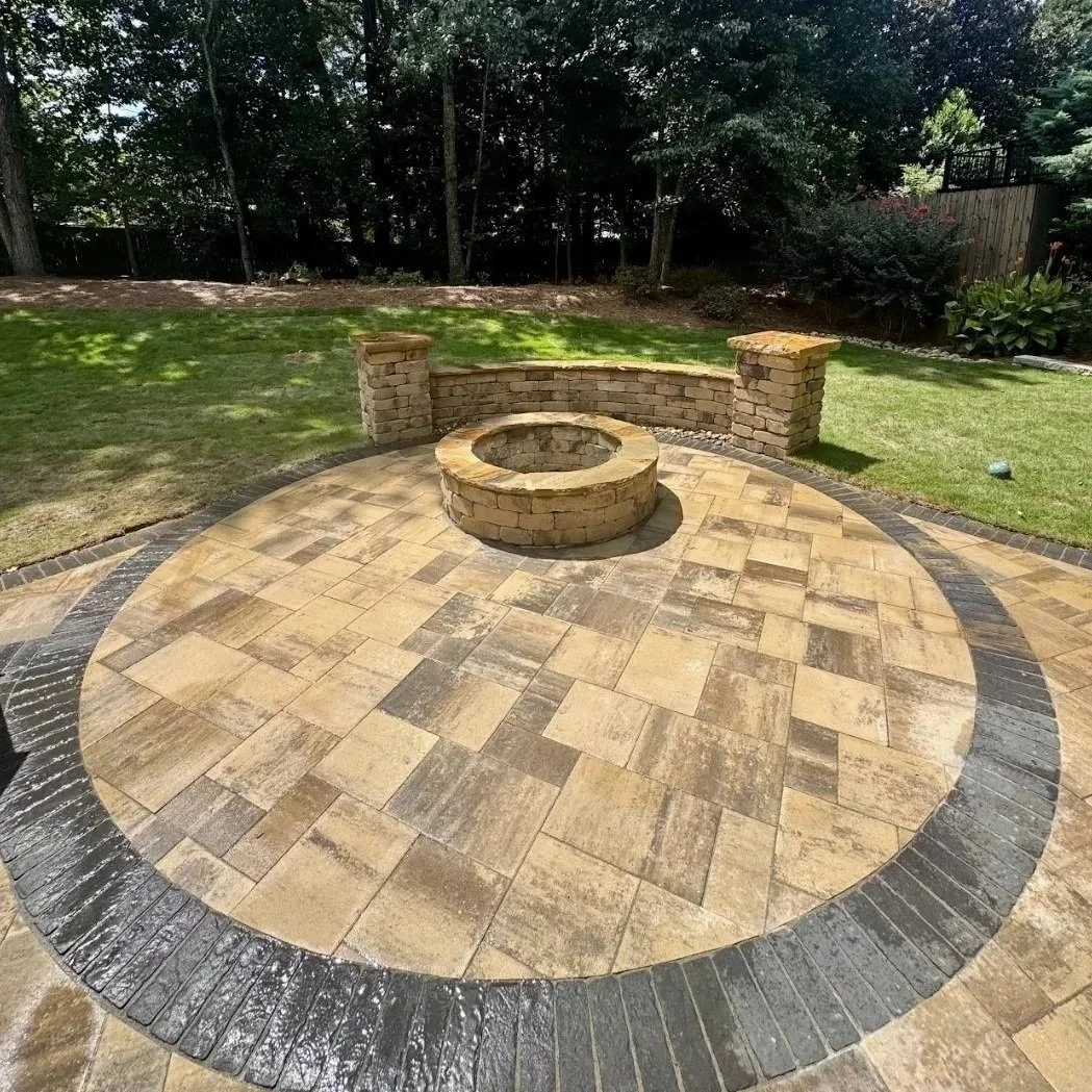 Outdoor fire pit in Georgia, wet from rain, showing metal components and fire media exposed to humid, rainy conditions.