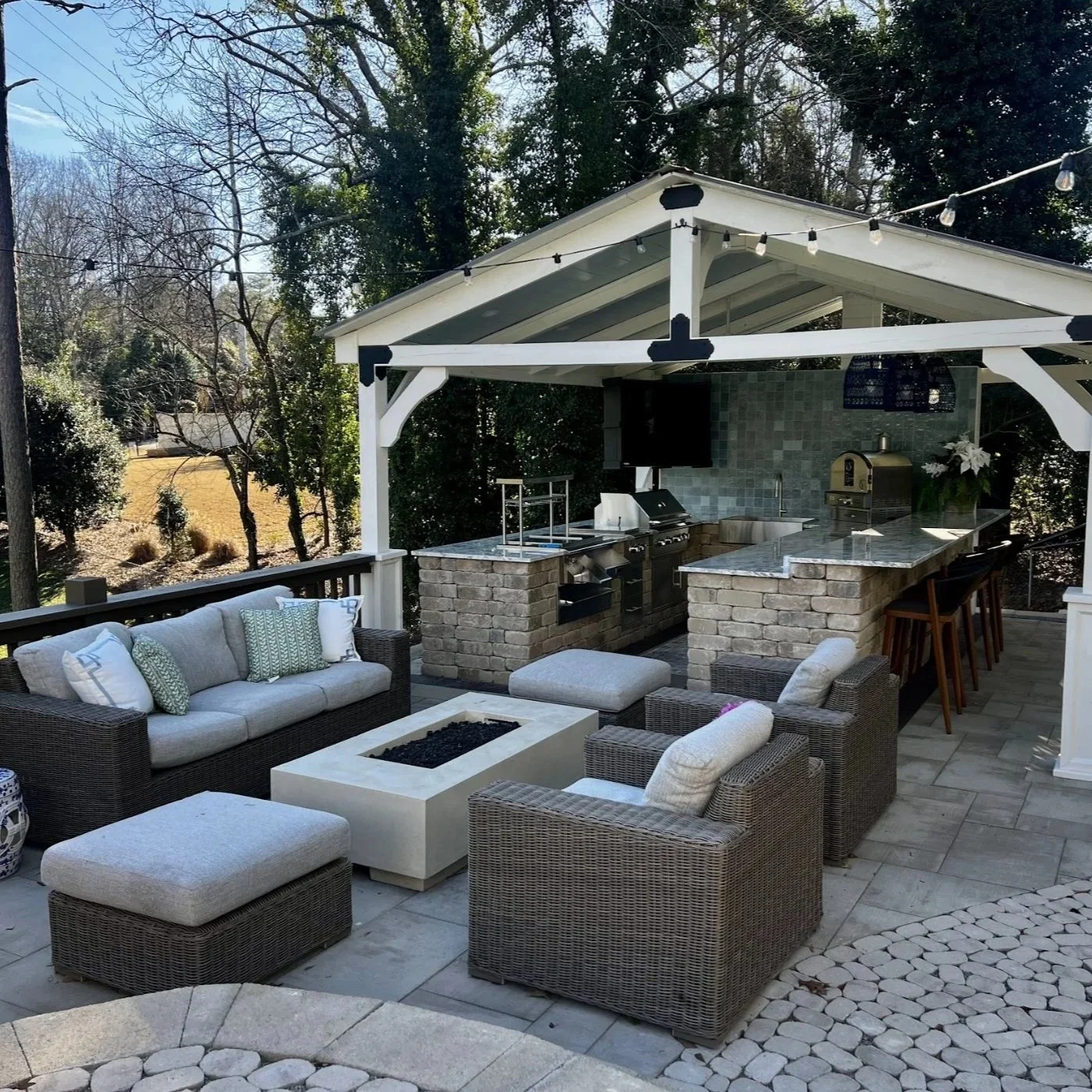 Backyard fire pit in Gainesville, GA, surrounded by seating, creating cozy ambiance for family gatherings and outdoor entertaining year-round.