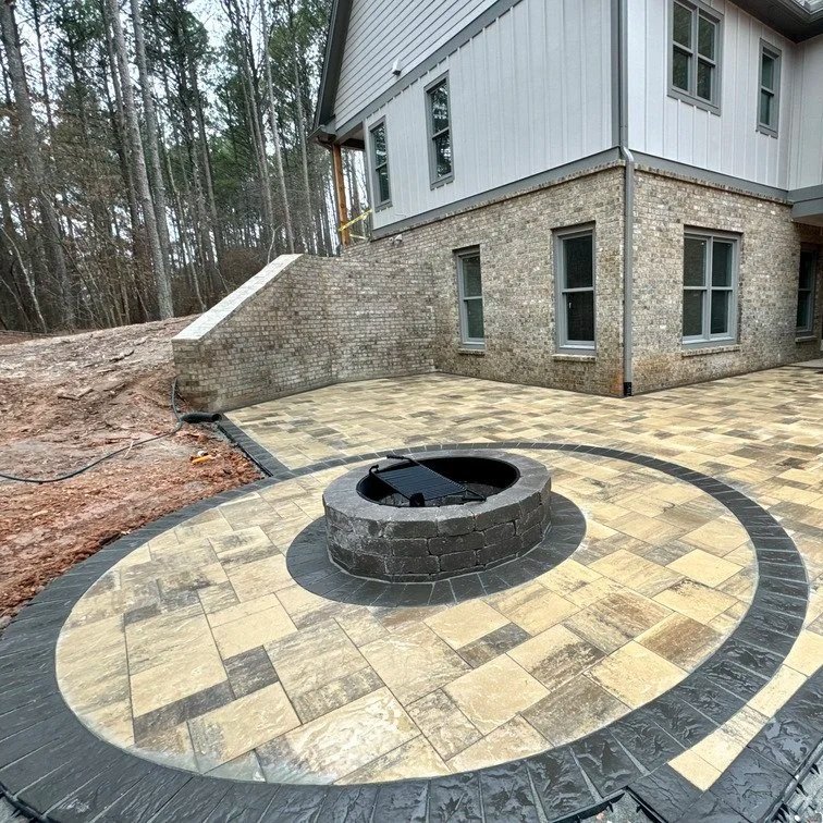 Outdoor fire pit in backyard, surrounded by seating, ideal placement for safety, comfort, and gatherings, enhancing evening relaxation and entertainment.