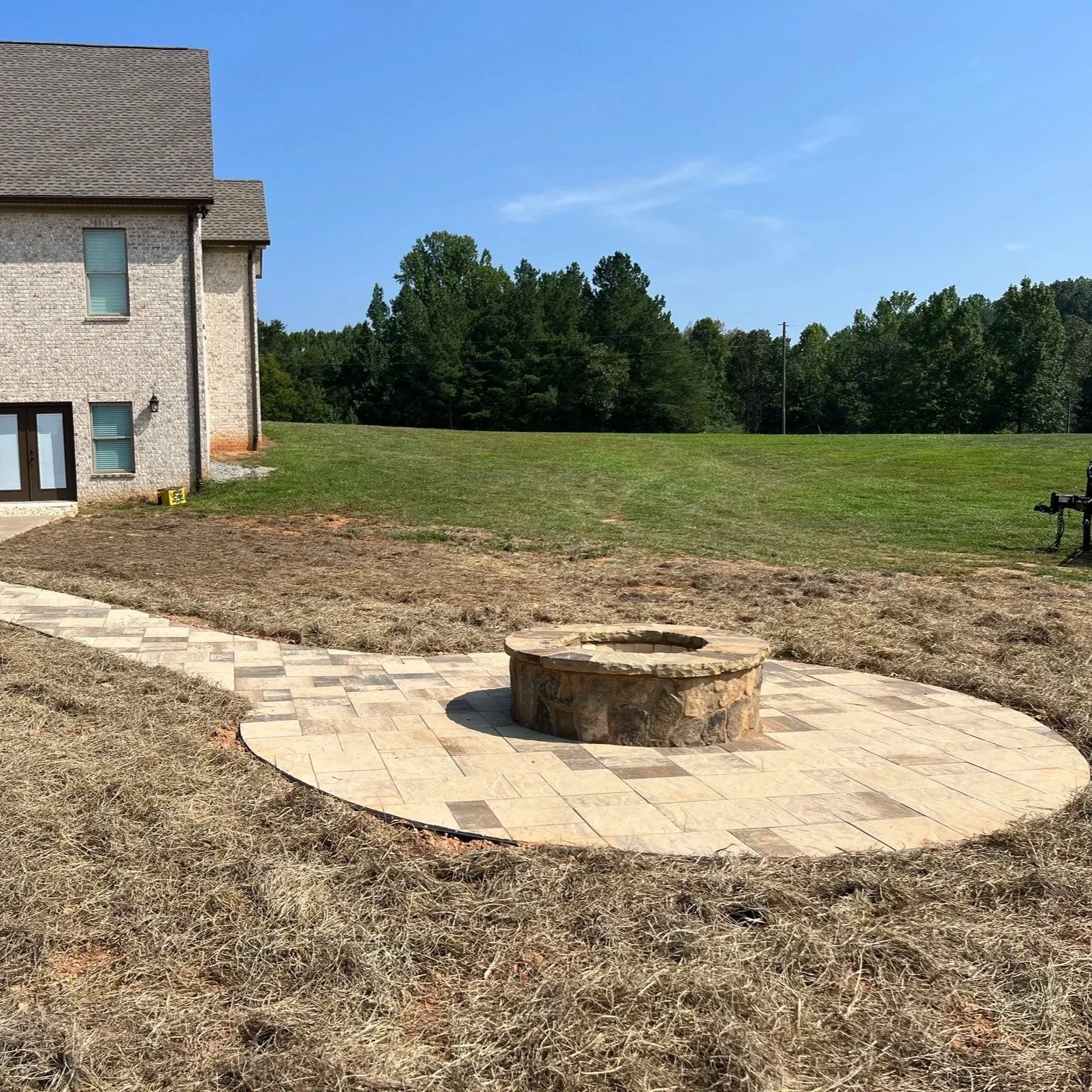 Backyard fire pit in Gainesville with friends enjoying a warm evening around wood-burning and gas fire pits.