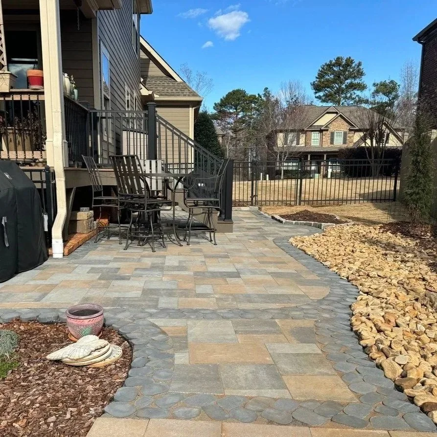 Eco-friendly permeable pavers in a Gainesville garden, managing stormwater, reducing runoff, and promoting sustainable landscape drainage and soil absorption.