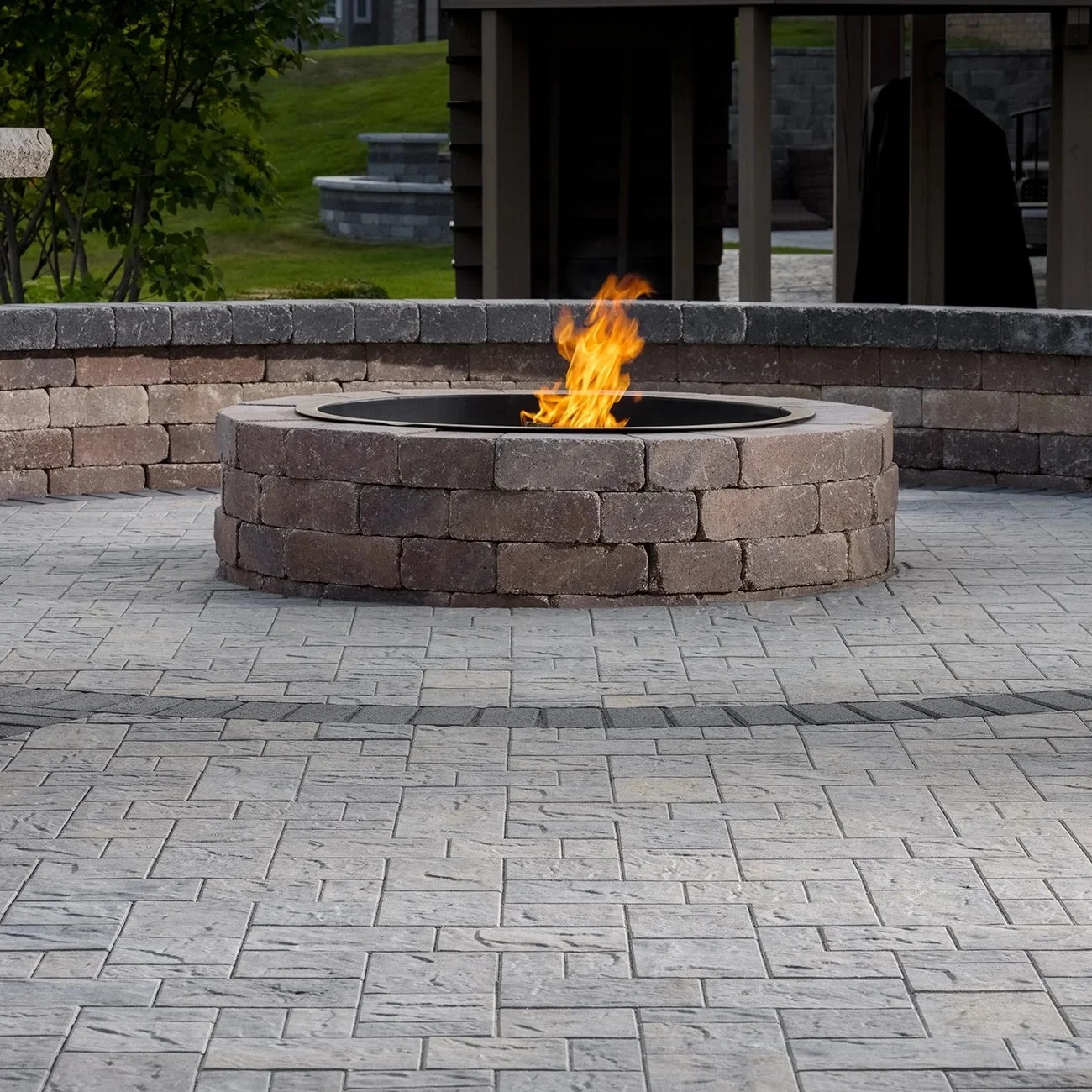 Backyard fire pit in Gainesville, FL, surrounded by patio seating, illustrating outdoor living, cooking, and entertainment amid humid conditions.