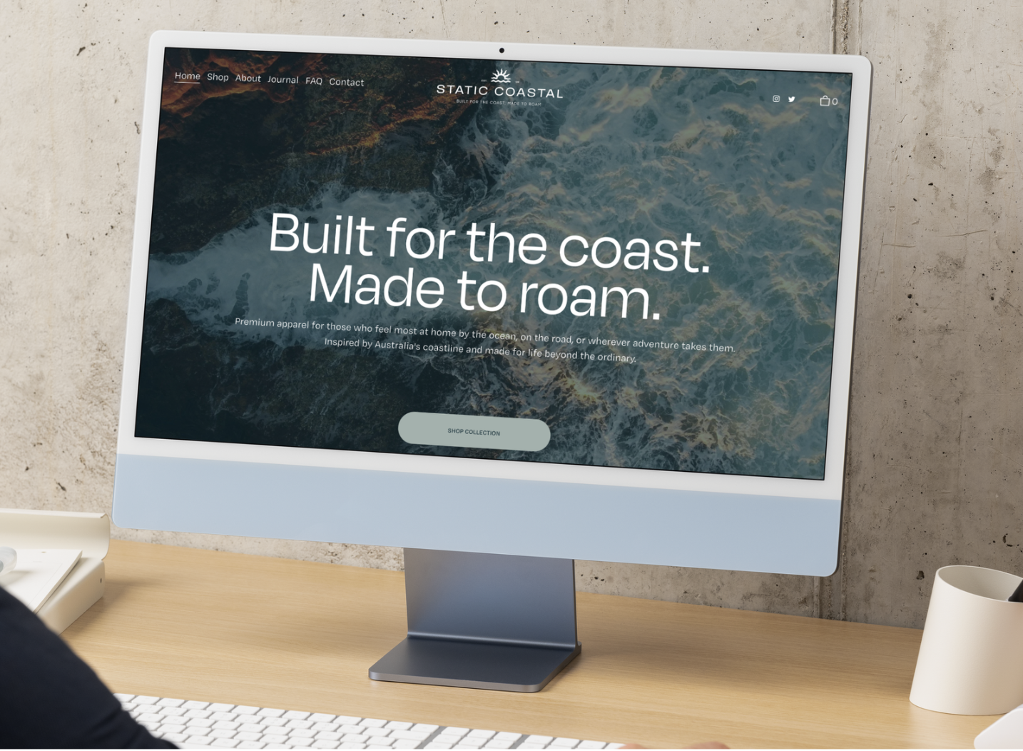 Computer screen displaying a website for Static Coastal, featuring a coastal background image and the text 'Built for the coast. Made to roam.' with a 'Shop Collection' button.
