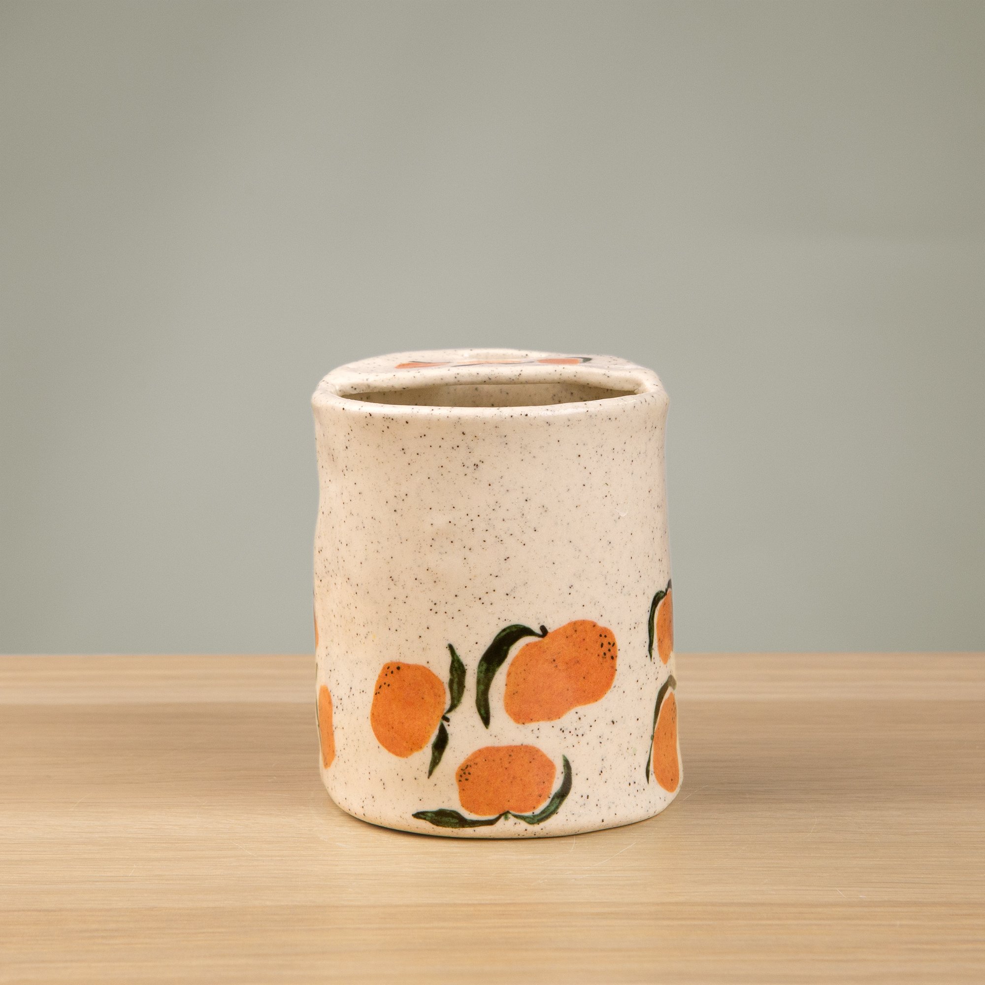 Handmade speckled ceramic mandarin travel cup decorated with sweet mandarin illustrations