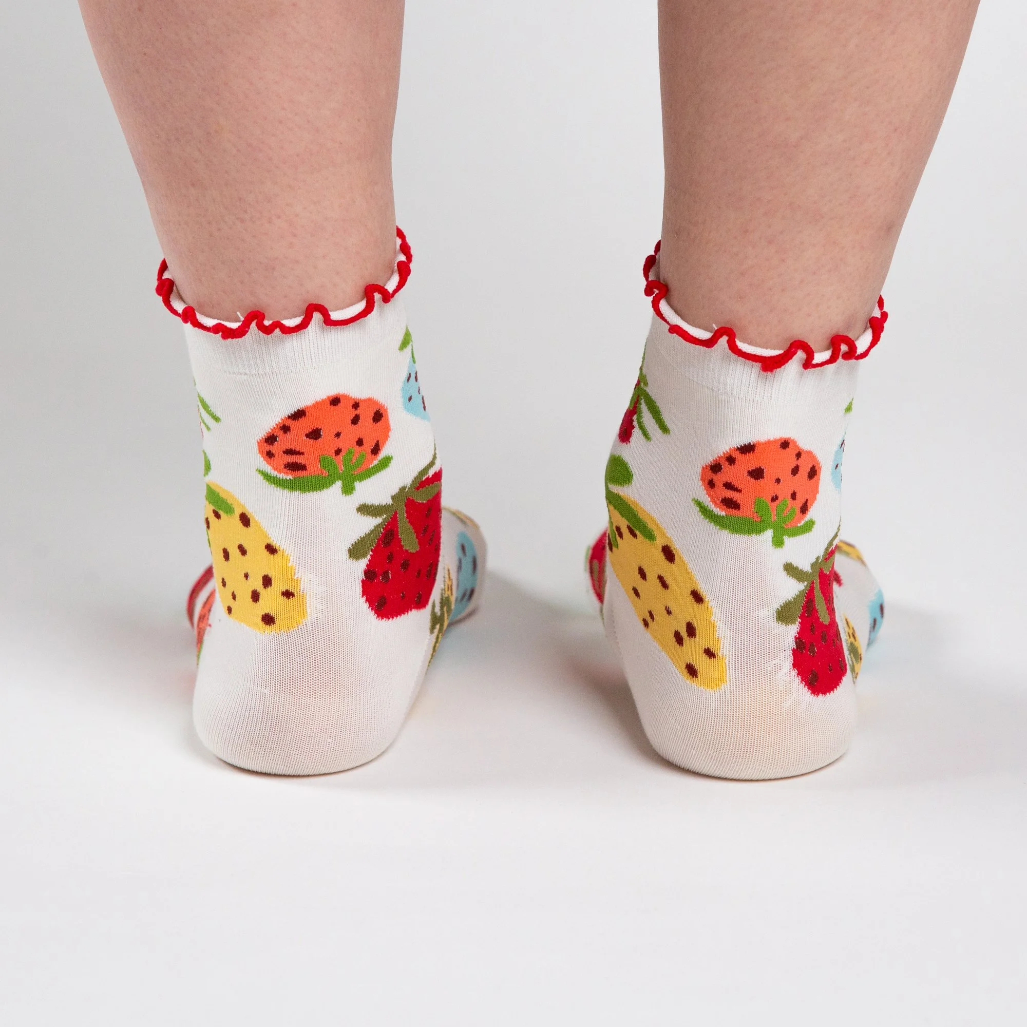 Soft ankle socks featuring the hand-painted Strawberry Dream print and a playful red frill. Comfortable, colourful and perfect for everyday wear.