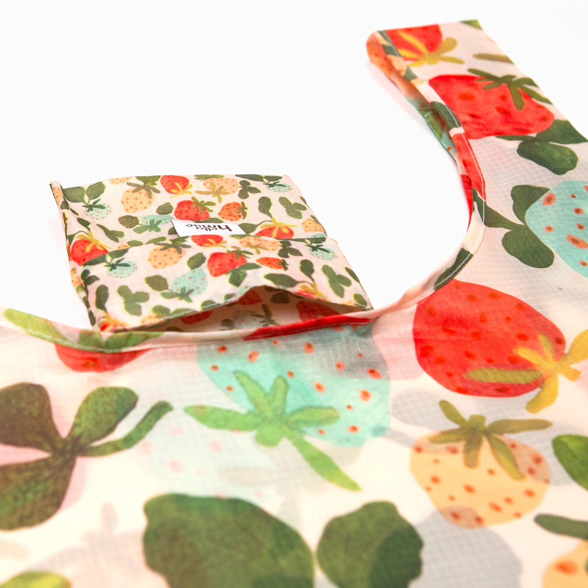 Lightweight foldable shopping bag made from recycled PET, featuring the hand-painted Strawberry Dream print. Folds into an 11 × 11 cm pocket for easy everyday use.