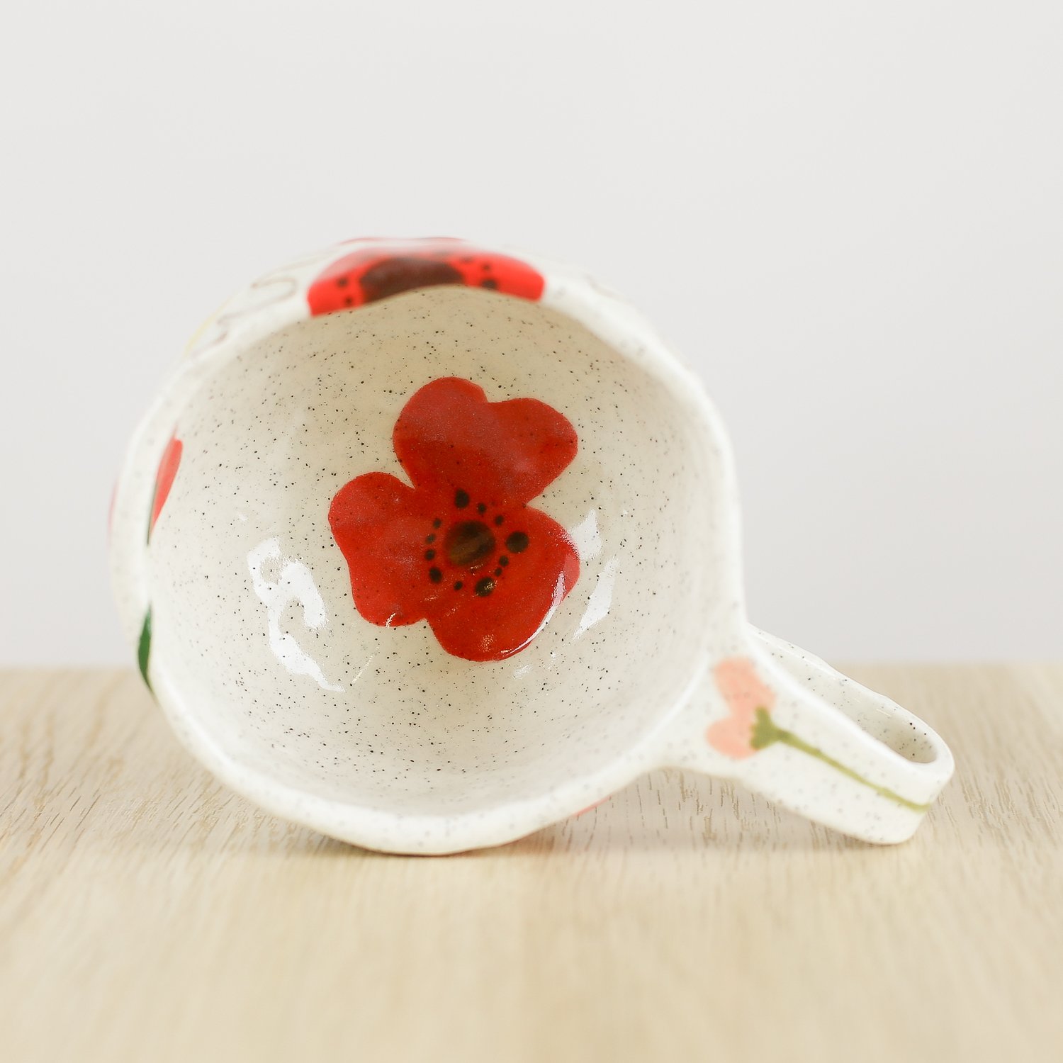 Handmade ceramic cup with hand-painted poppies, daisies and sweet pea flowers. Holds 150ml. A unique floral coffee cup for everyday rituals.